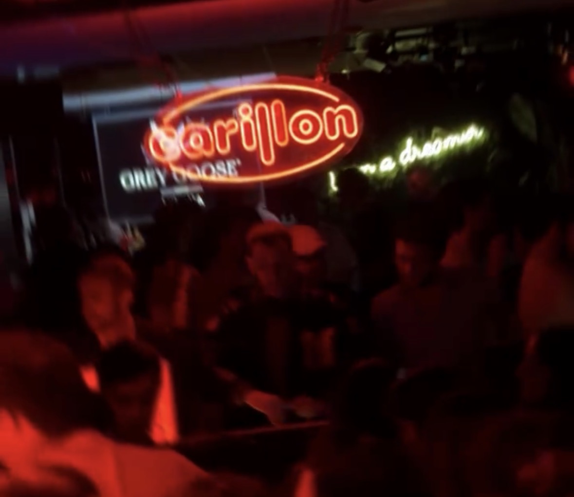 The neon CARILLON sign hanging over the crowd